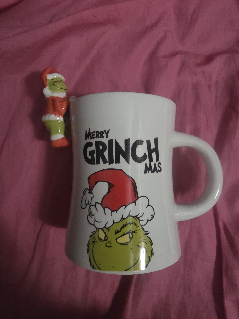 Merry Grinchmas White Ceramic Mug with the grinch hanging over the rim
